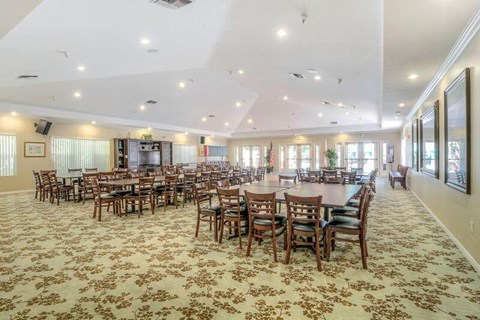 a large dining room with tables and chairs